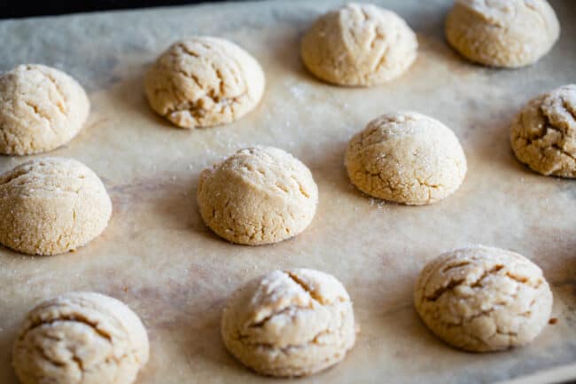 peanut butter cookies puffed up on a pan.