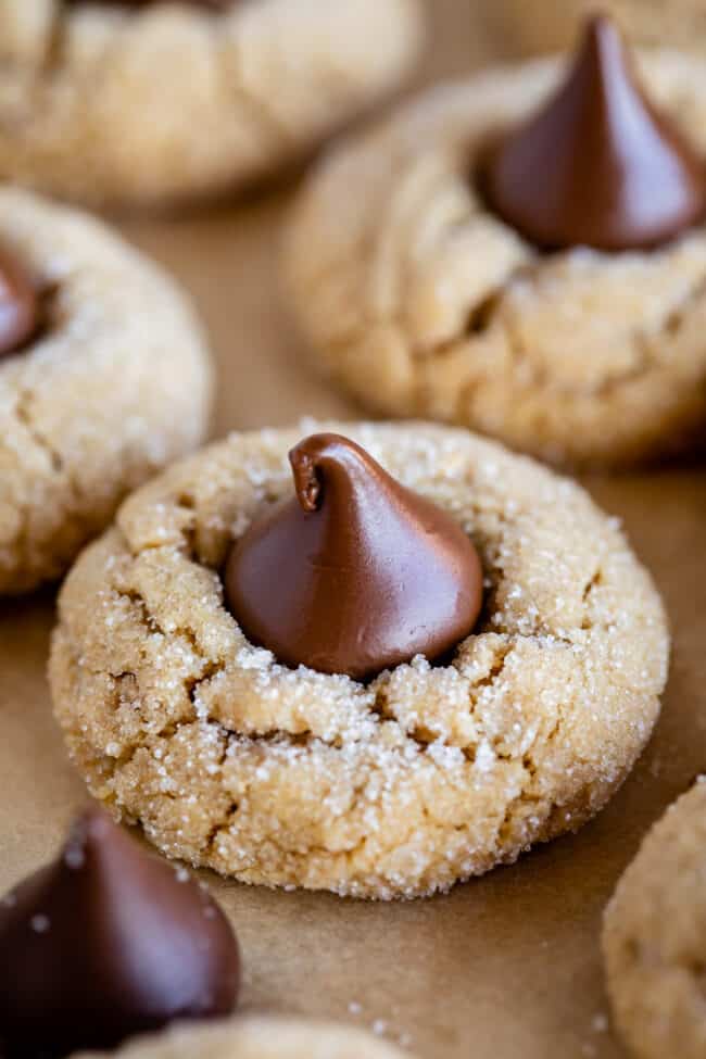 Hershey's peanut butter kiss cookies on parchment paper.