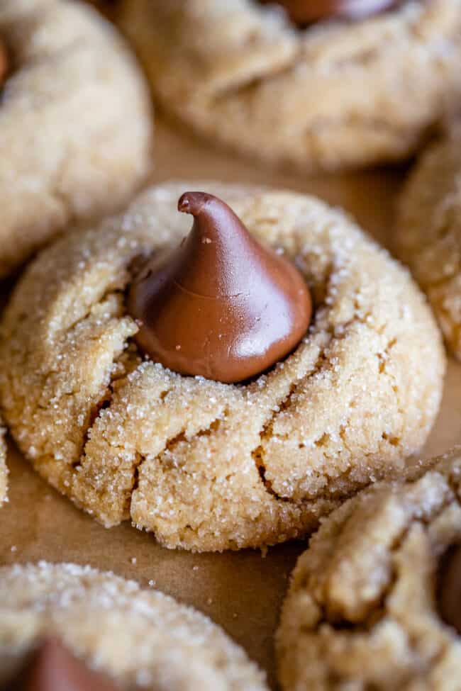 peanut butter blossoms with Hershey's kisses on parchment paper.
