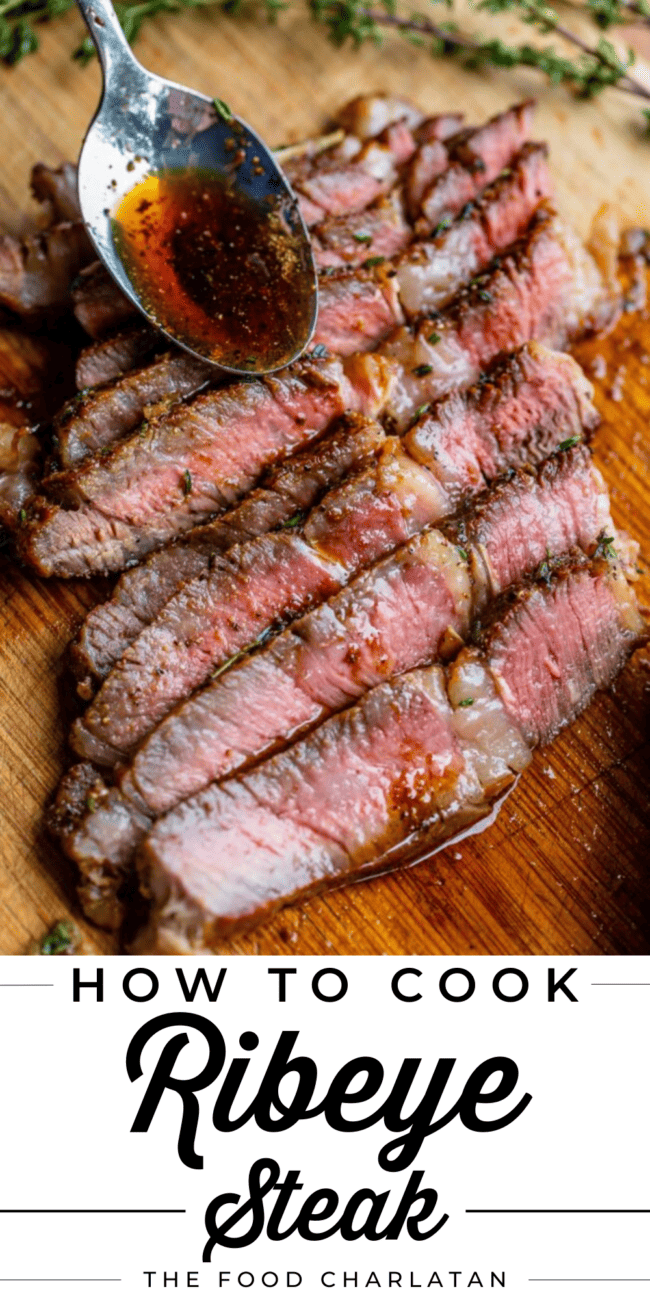 sliced ribeye steak on a wooden cutting board.
