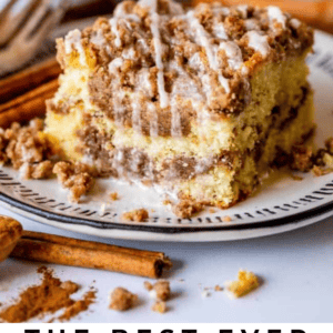 A slice of sour cream coffee cake with cinnamon streusel and glaze sits on a plate, alongside a fork and cinnamon sticks. Text reads: Sour Cream Coffee Cake with Cinnamon Swirl.