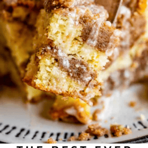 A fork lifts a bite of moist sour cream coffee cake topped with cinnamon streusel and icing drizzle, with more cake on a plate below. Text overlay reads “Sour Cream Coffee Cake with Cinnamon Streusel Topping.”.