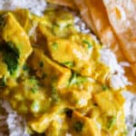 easy curry recipe placed on rice with roti in the background