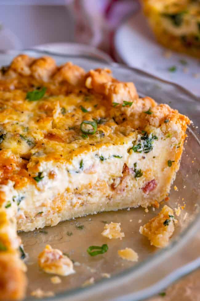 easy quiche in a glass pie pan shot from the side.