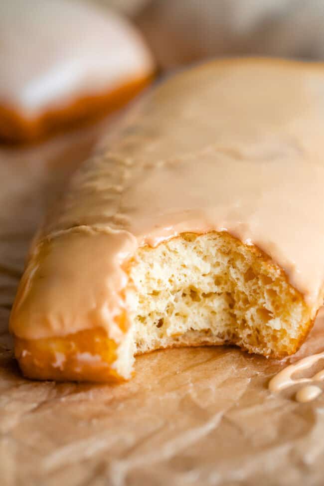 donut with bite taken out with maple glaze for donuts