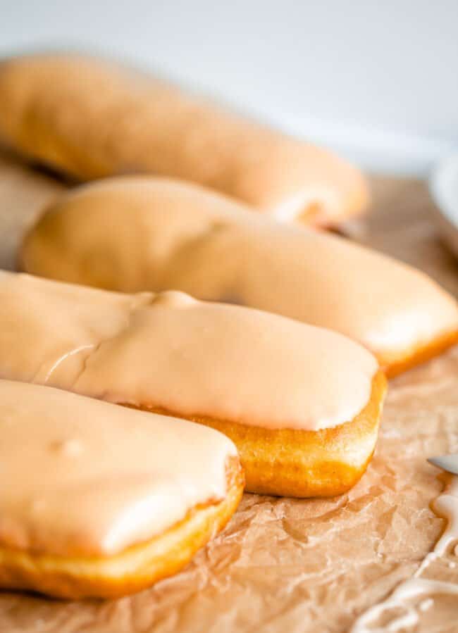 maple glaze for donuts on 3 donuts lined up in a row