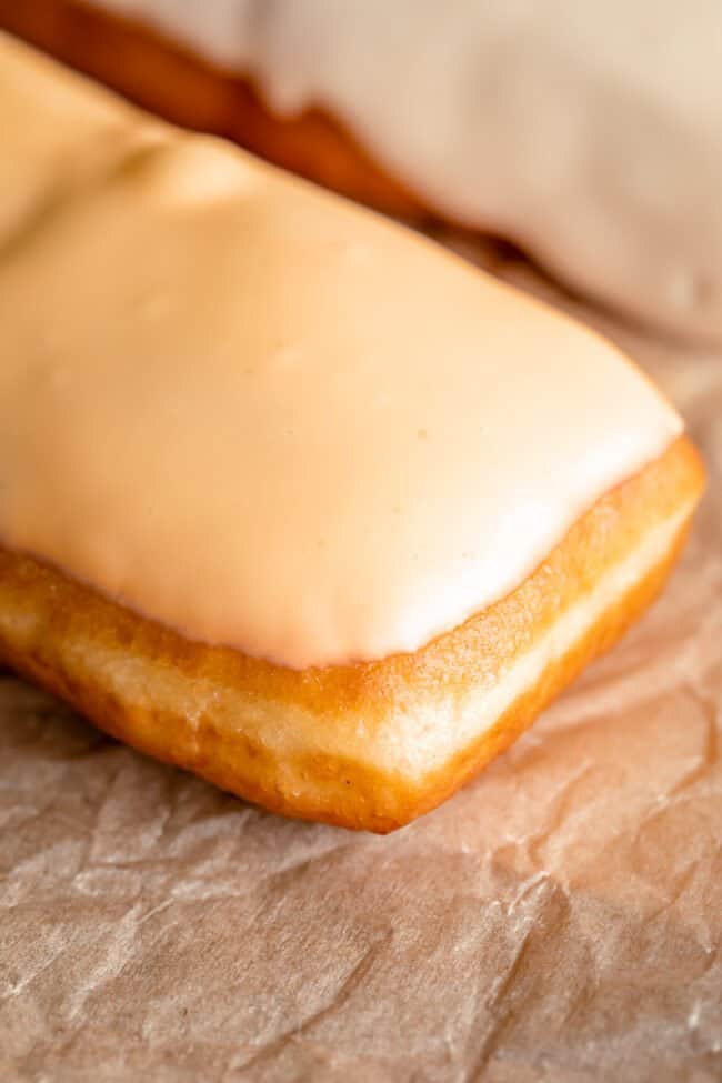 maple bar with glaze on parchment paper