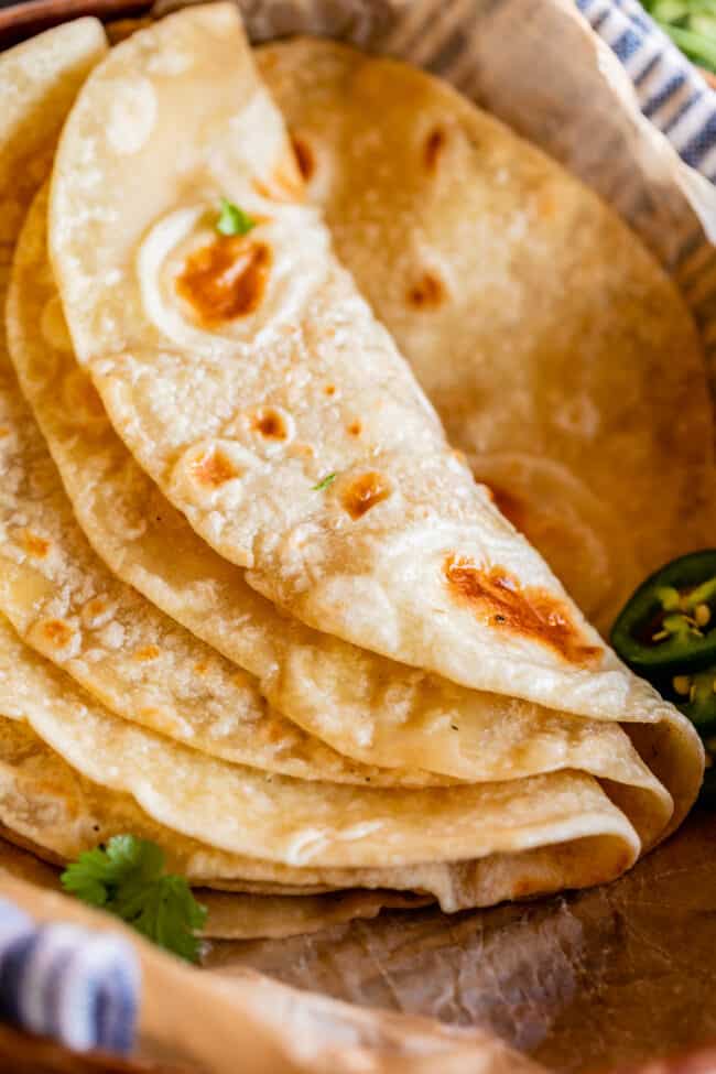 soft roti recipe folded over in parchment paper with cilantro