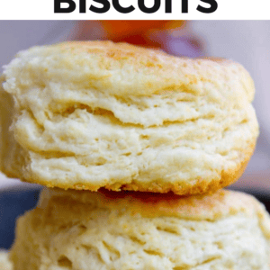 A close-up of three stacked, golden, flaky buttermilk biscuits with a soft, layered texture. Text above reads Flaky Buttermilk Biscuits.