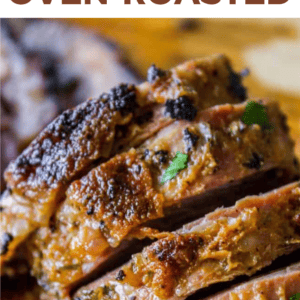 Close-up of juicy, sliced tri tip steak garnished with herbs, with text above that reads How to Cook Tri Tip Steak Grilled or Oven-Roasted and The Food Charlatan at the bottom.