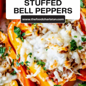 Close-up of colorful stuffed bell peppers topped with melted cheese and chopped parsley, with a label reading Classic Stuffed Bell Peppers and a website link.