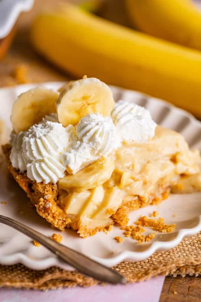 recipe for banana cream pie, sliced on a scalloped edge plate.