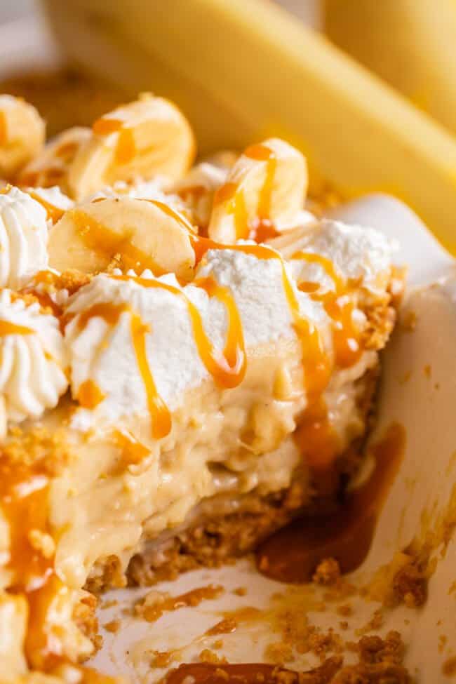 banana cream pie made from scratch (no pudding) in a pie pan, drizzled with caramel.