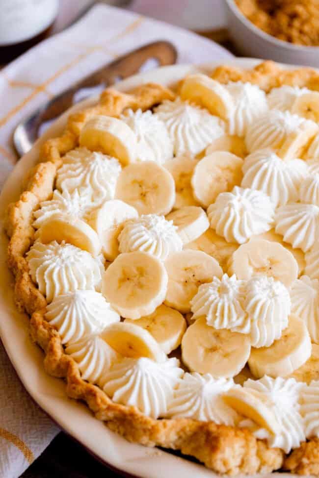 homemade banana cream pie in a pastry crust with whipped cream.