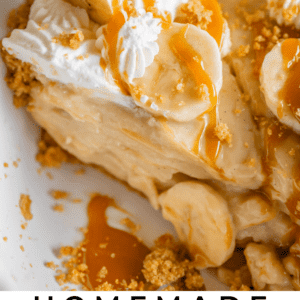 slice of banana cream pie drizzled with caramel in a white pie pan.
