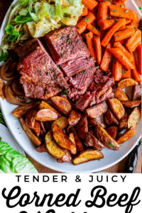 crockpot corned beef on a large platter with carrots potatoes and cabbage