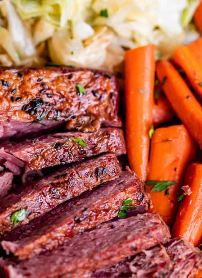 crockpot corned beef sliced from overhead, with carrots and cabbage.