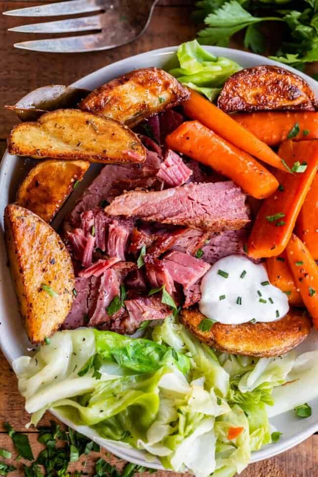 corned beef and cabbage on a plate with potatoes and carrots.