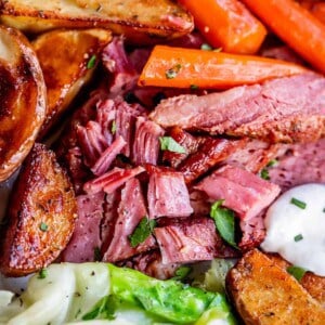 corned beef recipe, shredded on a plate with cabbage, carrots, and potatoes