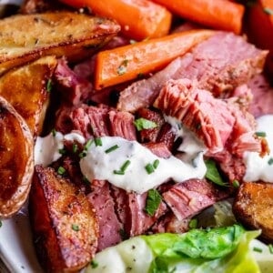 corn beef and cabbage on a plate with potatoes and carrots and cabbage