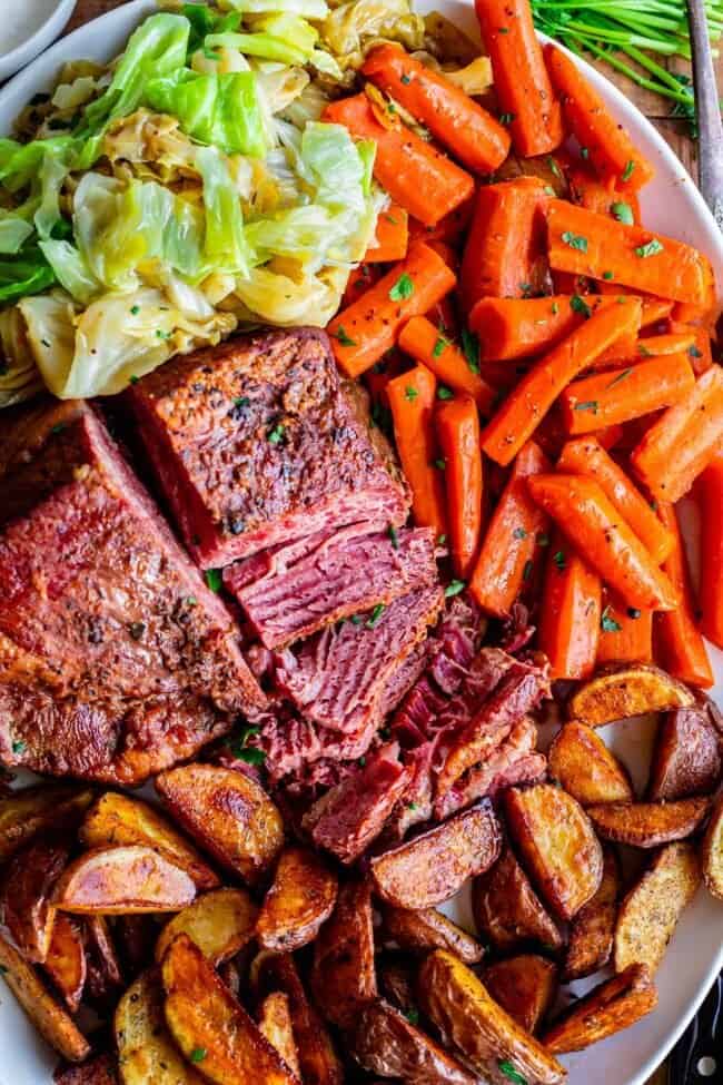 corned beef recipe with carrots, cabbage, potatoes on a platter.