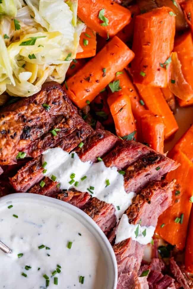 horseradish sauce for corned beef spread over slices, with carrots.