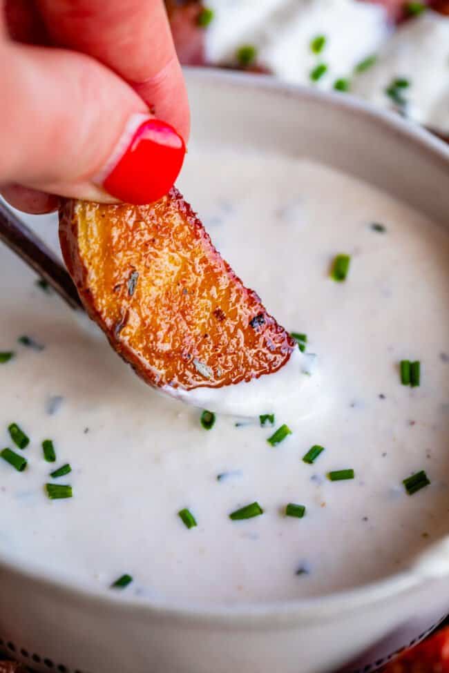 dipping a roasted potato into horseradish sauce.