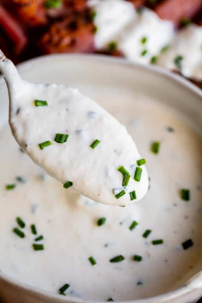 horseradish sauce on a spoon with chives.