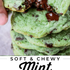 stack of green mint cookies with hand picking up the top one