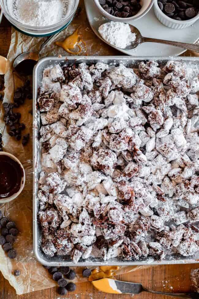 puppy chow with powdered sugar on a baking sheet shot from overhead