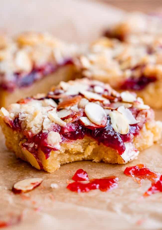 raspberry shortbread bar with jam with a bite taken.