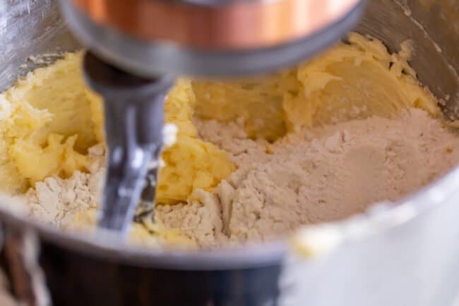 mixing dry ingredients into creamed butter in a stand mixer.