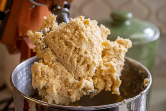 shortbread dough on the paddle of a stand mixer.