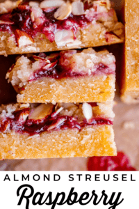 stacked up raspberry shortbread bars with jam.
