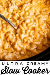 slow cooker mac and cheese with a serving spoon.