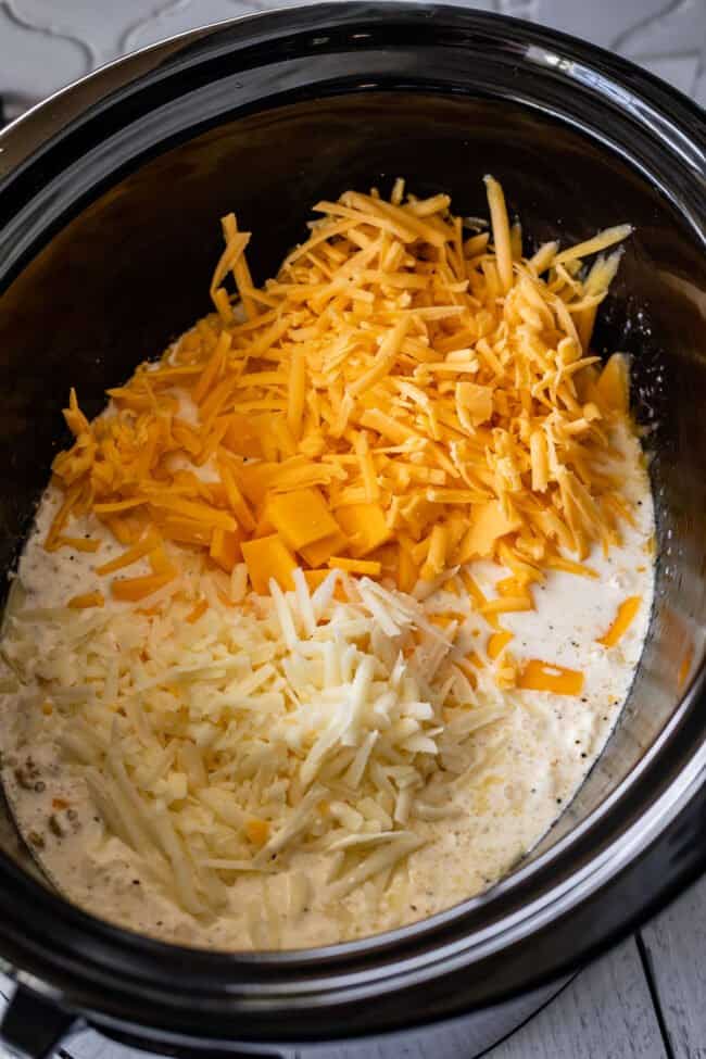 noodles, milk, and 3 cheeses added to a crockpot.