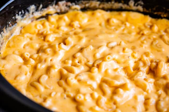 creamy mac and cheese in a slow cooker, shot from side.