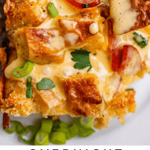 Overnight eggs benedict casserole on white plate.