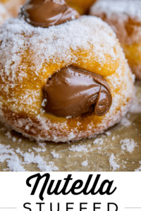 Nutella stuffed donut coated with sugar and topped with nutella.