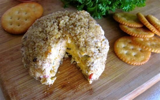 Pimiento cheese call with slice cut out and ritz crackers.