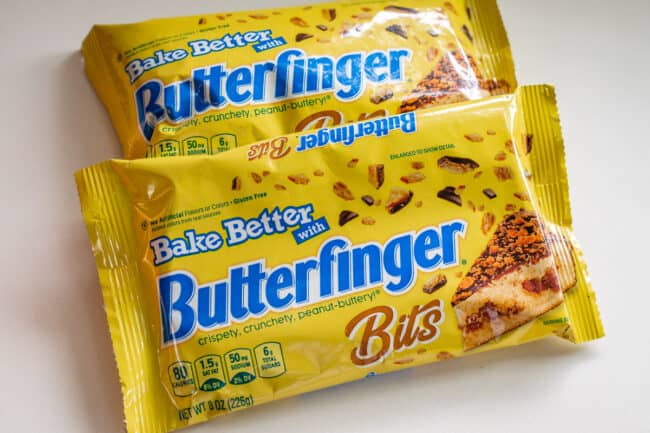 two bags of Butterfinger Bits on a white counter.