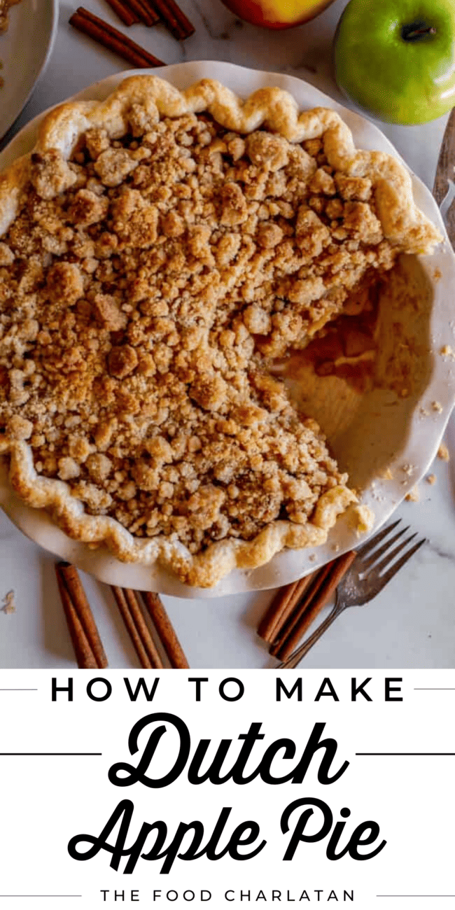 dutch crumble top apple pie with a big piece cut out.