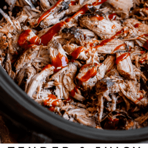 slow cooker pulled pork in a black crock pot with bbq sauce.