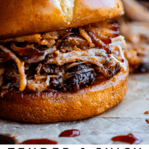 pulled pork sandwich on a hamburger bun with bbq sauce on parchment paper.