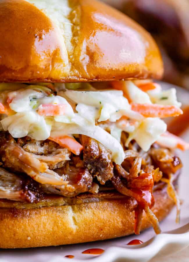 close up of bbq smoked pulled pork sandwich with coleslaw.