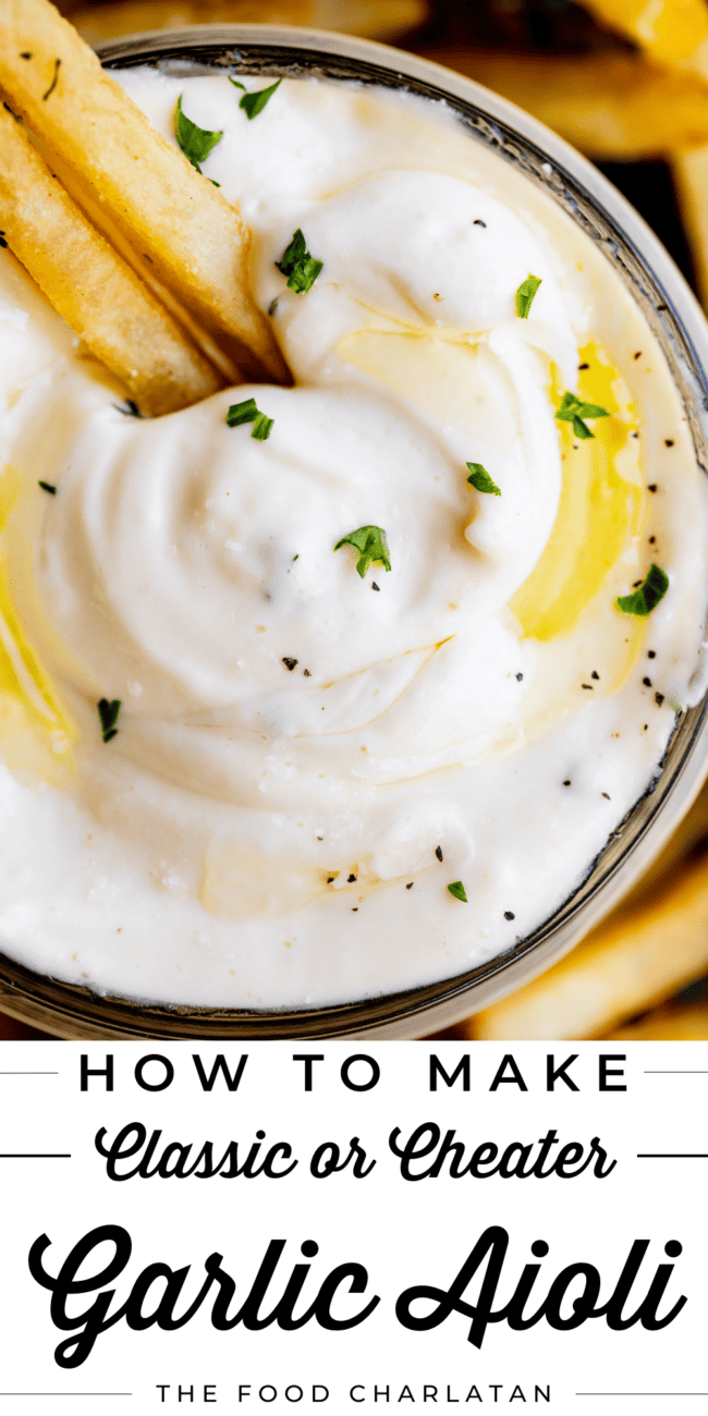 garlic aioli in a glass container with fries dipped in it.