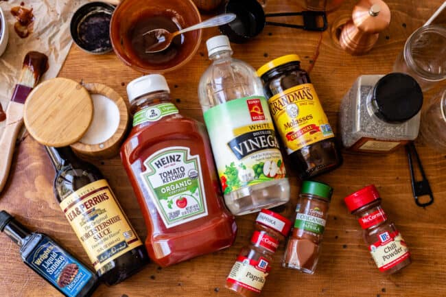 ingredients for bbq sauce displayed on a wooden table.