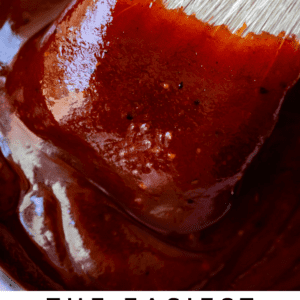 white brush dipping into barbecue sauce.