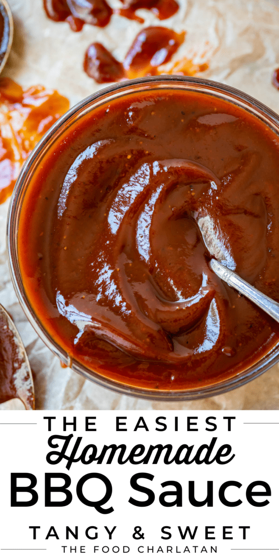 bowl of bbq sauce with a spoon on parchment paper.