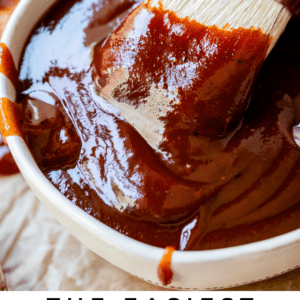 brush dipping into white bowl of barbecue sauce.